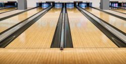 Bowling wooden floor with lane, Generic Bowling Alley lanes with bowling ball going towards the pins.