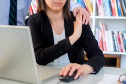 Young employee worker touched by his boss and feeling uncomfortable