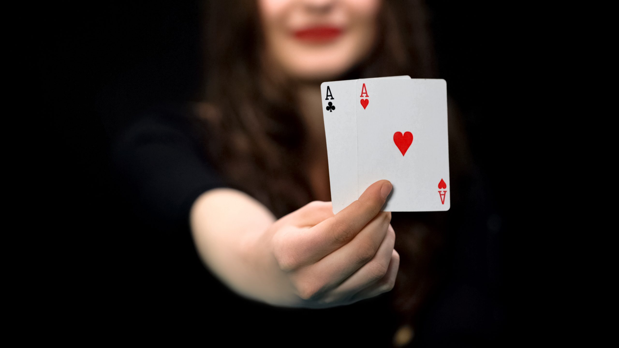 Female hand holding hearts and clubs aces, card pair, advantage, win chance