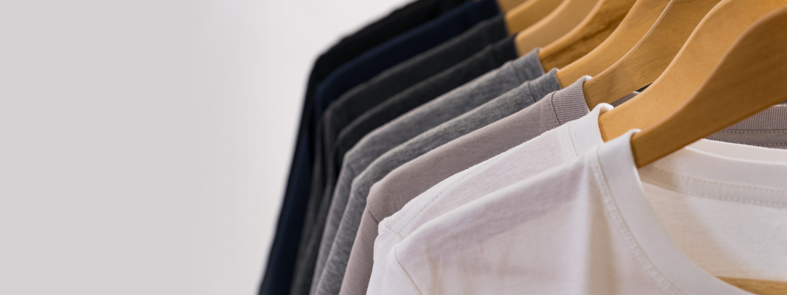 Close up of T-shirts on hangers, apparel background